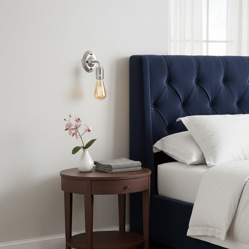 Navy blue upholstered bed with white bedding in a bedroom setting.