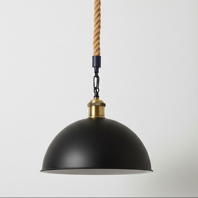 Black pendant light with gold accents and a rope cord on a white background