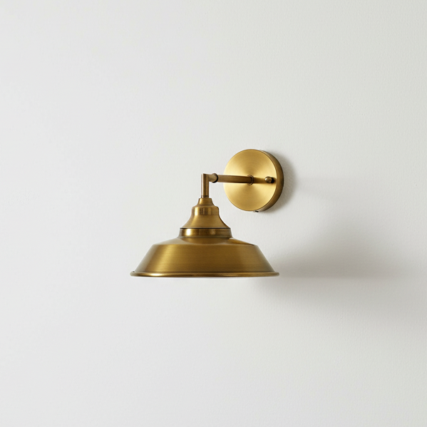 Brass wall sconce on a white wall