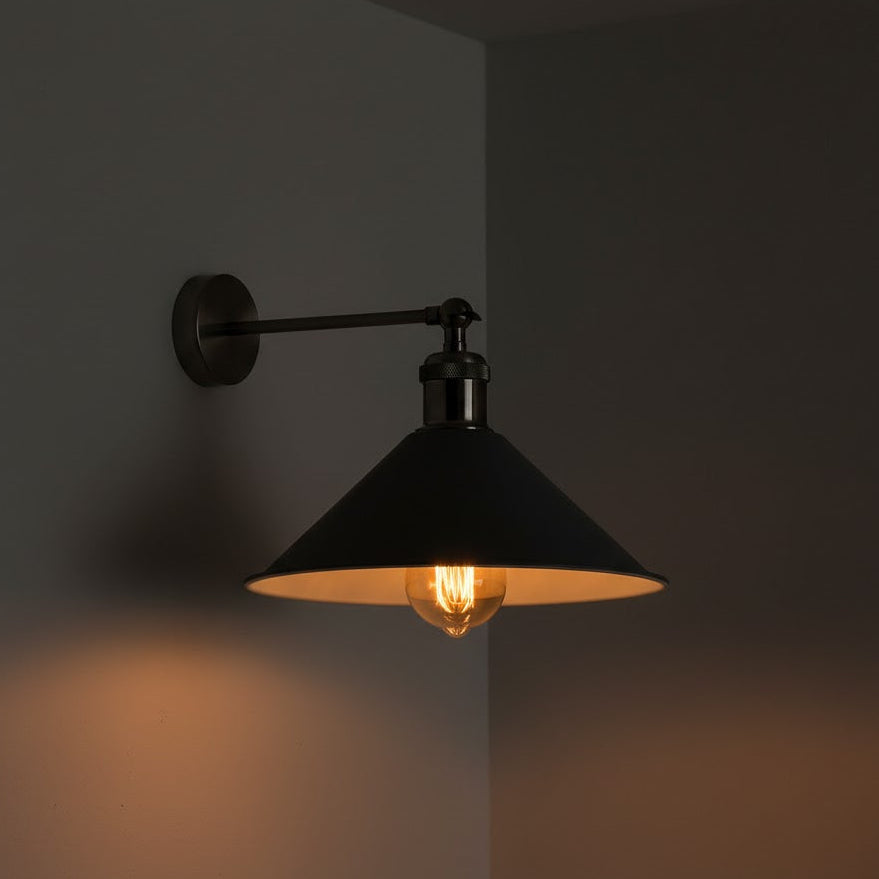 Black wall-mounted lamp with a lit bulb on a dark background