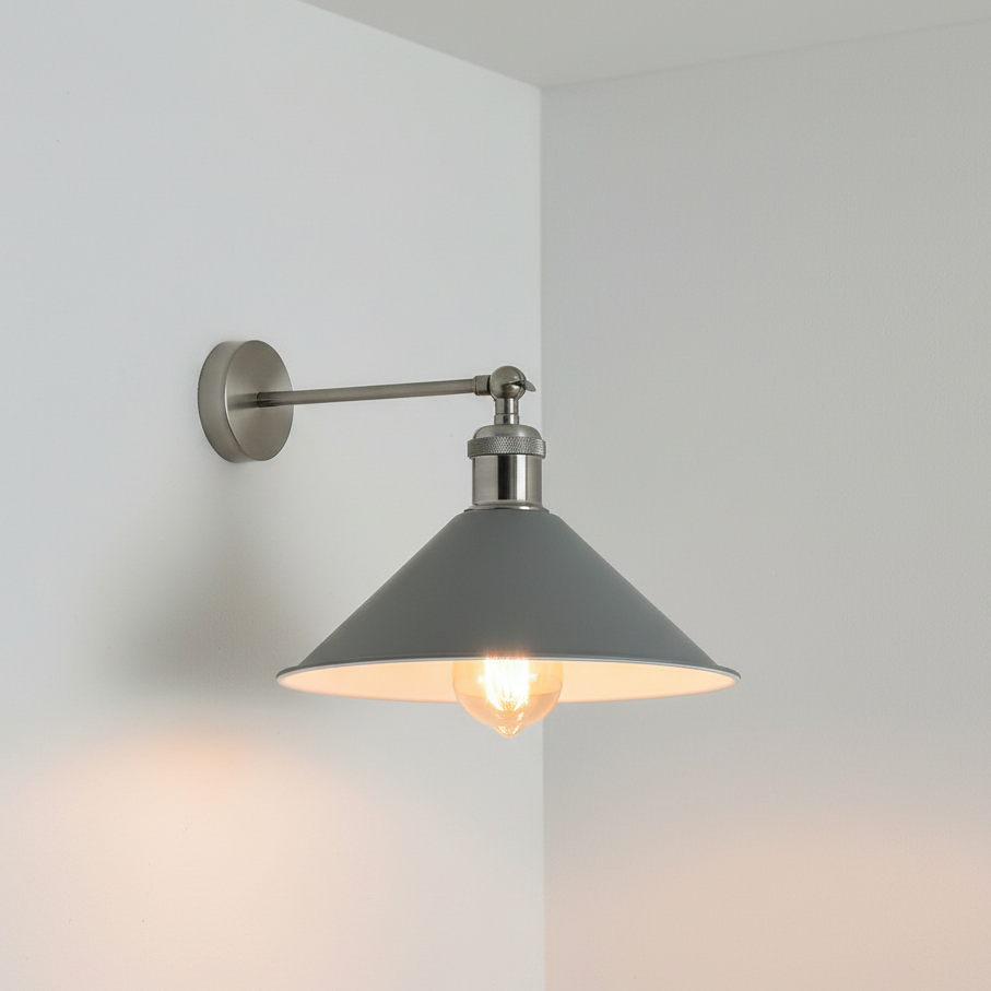 Wall-mounted light fixture with a gray shade on a white wall.