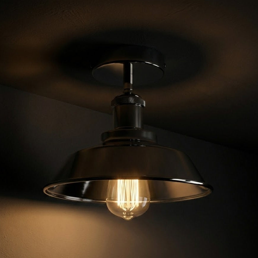 Vintage-style ceiling light fixture with a glowing bulb on a dark background