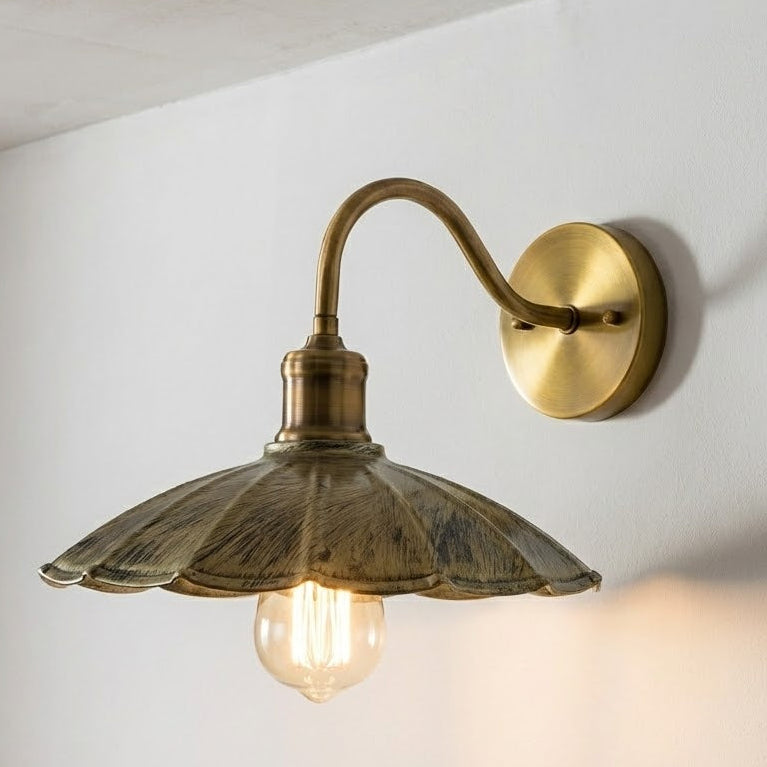 Vintage-style wall sconce with a glass shade on a white wall