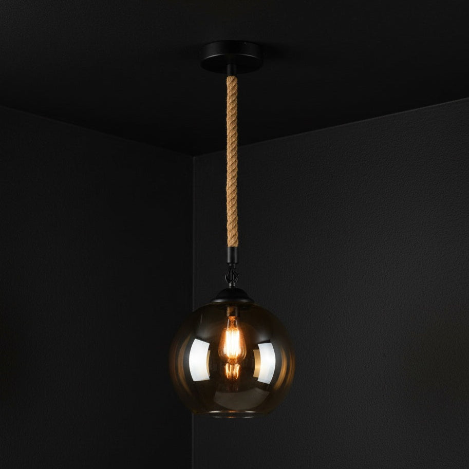 Pendant light with glass shade and visible bulb against a black background