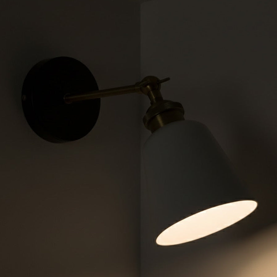 Wall-mounted lamp with a single light bulb on a dark background