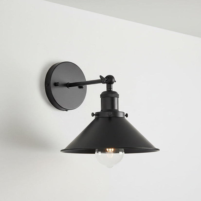 Black wall-mounted lamp with a white background