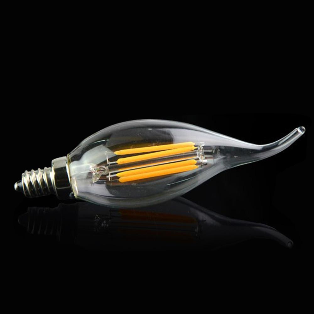 Clear LED light bulb with visible filaments on a black background