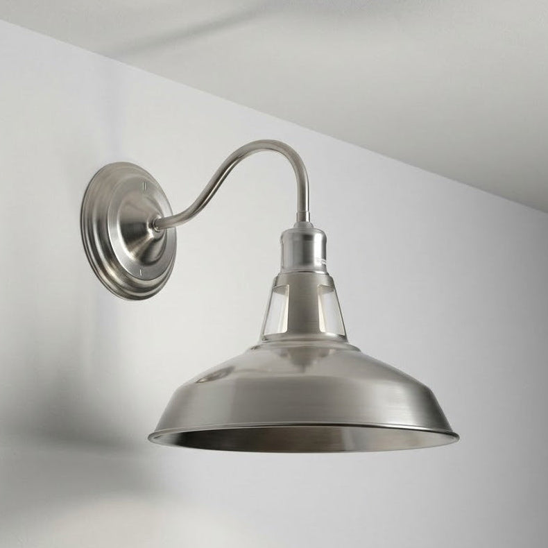 Metal wall-mounted light fixture on a white wall with a gray gradient.