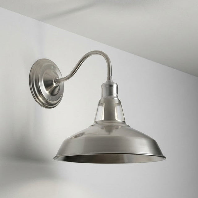 Metal wall-mounted light fixture on a white wall with a gray gradient.