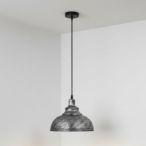 Pendant light with textured metal shade against a plain background