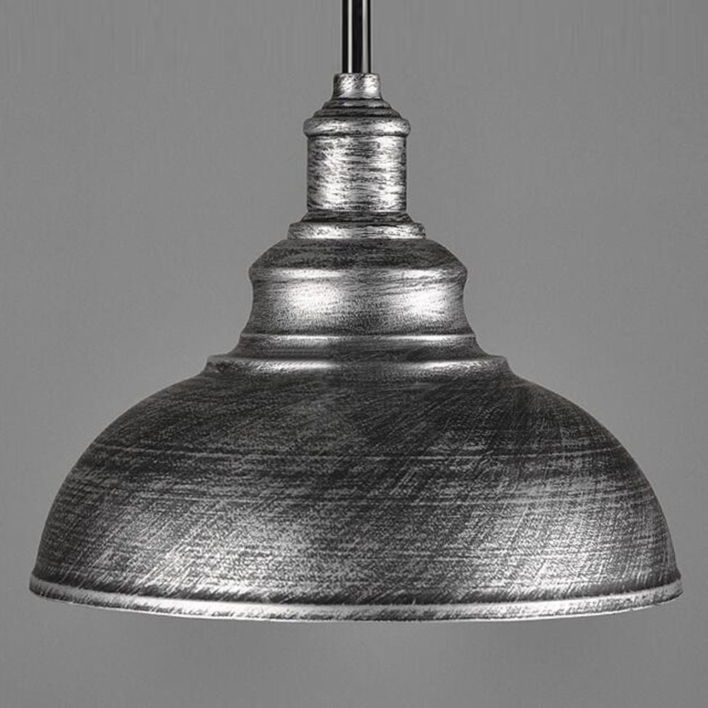 Metallic pendant light with a textured finish on a gray background