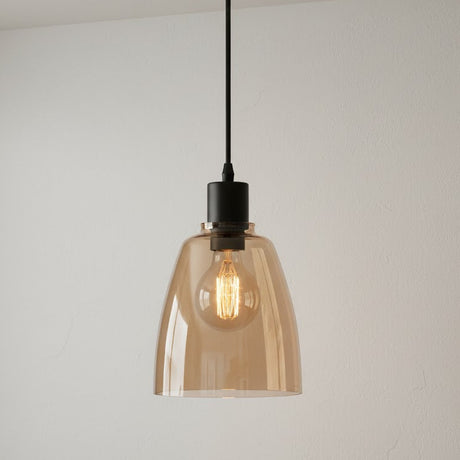 Pendant light with amber glass shade and black fixture on a plain background