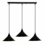 Black pendant light fixture with three hanging lampshades on a white background