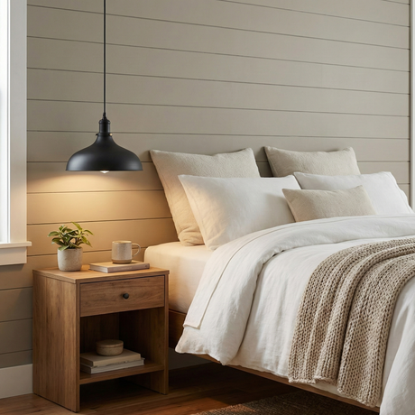 Cozy bedroom with wooden nightstand, bed with white bedding, and pendant light.