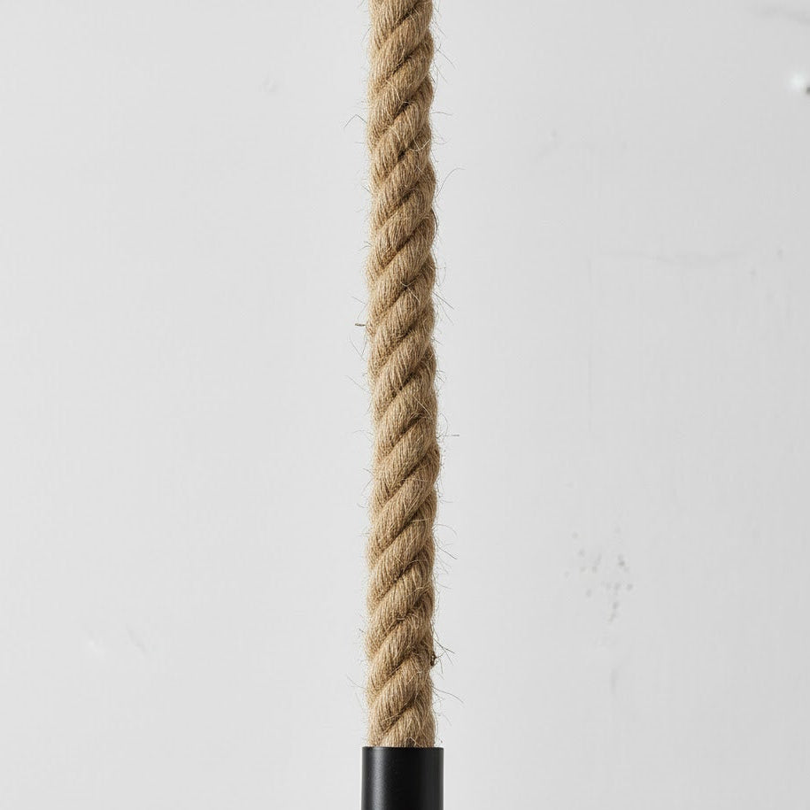 Natural rope with a black metal fitting on a light gray background
