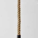 Natural rope with a black metal fitting on a light gray background