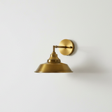 Brass wall sconce on a white wall