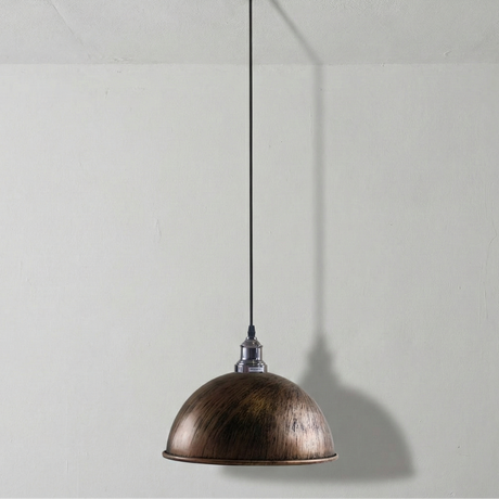 Bronze pendant light hanging against a plain white wall