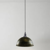 walnut brushed pendant light hanging against a plain background