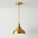 Gold pendant light fixture on a white background