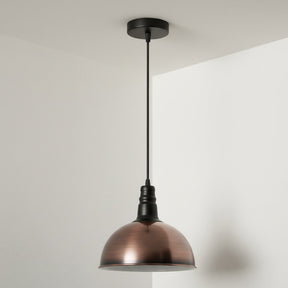 Bronze pendant light hanging against a white wall
