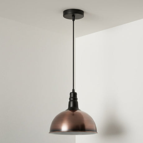 Bronze pendant light hanging against a white wall

