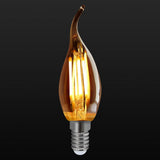 Decorative light bulb with a warm glow on a black background