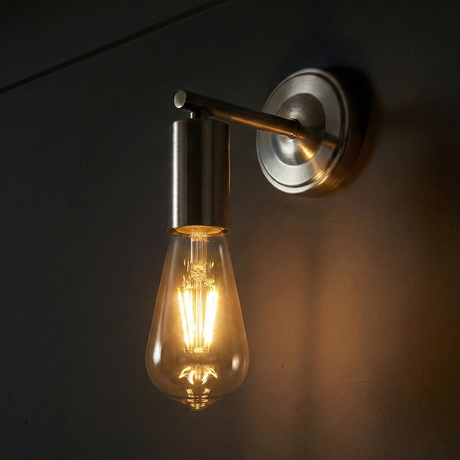 Wall-mounted light fixture with a glowing bulb on a dark background