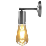 Metal wall light fixture with a glowing bulb on a white background