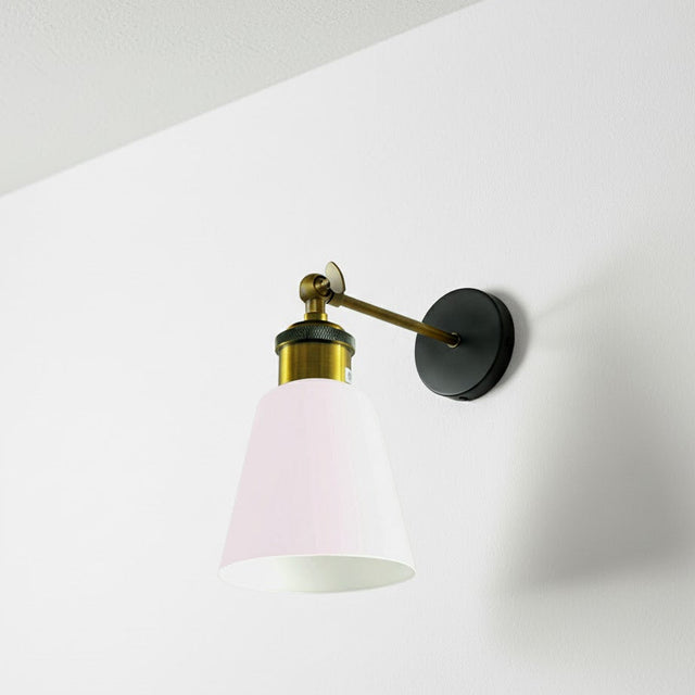 Wall-mounted lamp with pink glass shade on a white wall