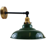 Green industrial-style wall lamp with brass accents on a white background