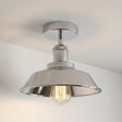 Metallic ceiling light fixture on a neutral background