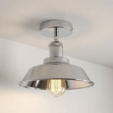 Metallic ceiling light fixture on a neutral background