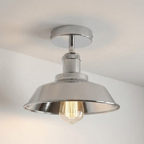 Metallic ceiling light fixture on a neutral background