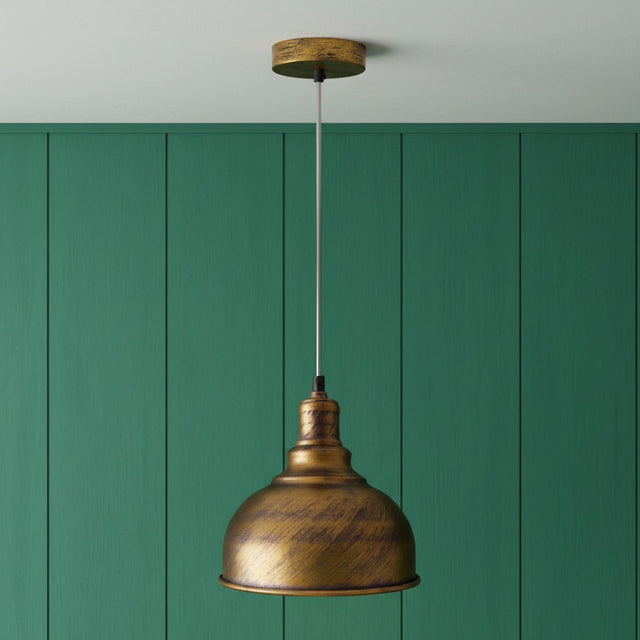 Bronze pendant light against a green paneled wall
