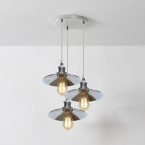 Modern pendant light fixture with three glass shades on a white background