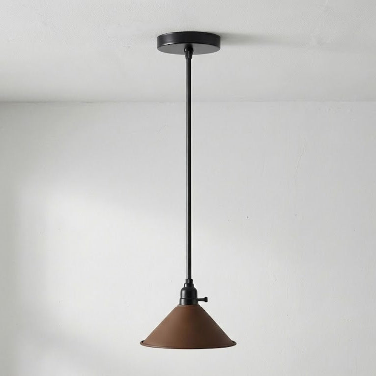 Pendant light with brown shade and black fixture on a white background