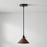 Pendant light with brown shade and black fixture on a white background