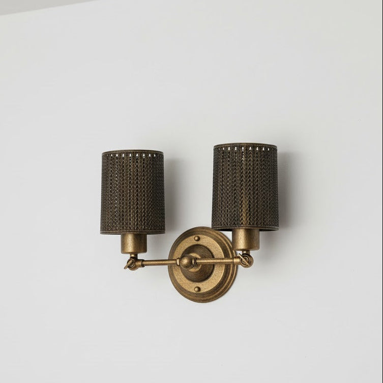 Brass wall sconce with two dark lampshades on a white background