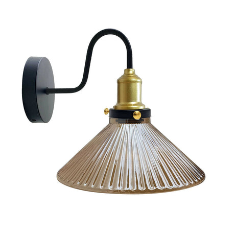 Wall-mounted lamp with black arm, brass fitting, and clear glass shade on a white background