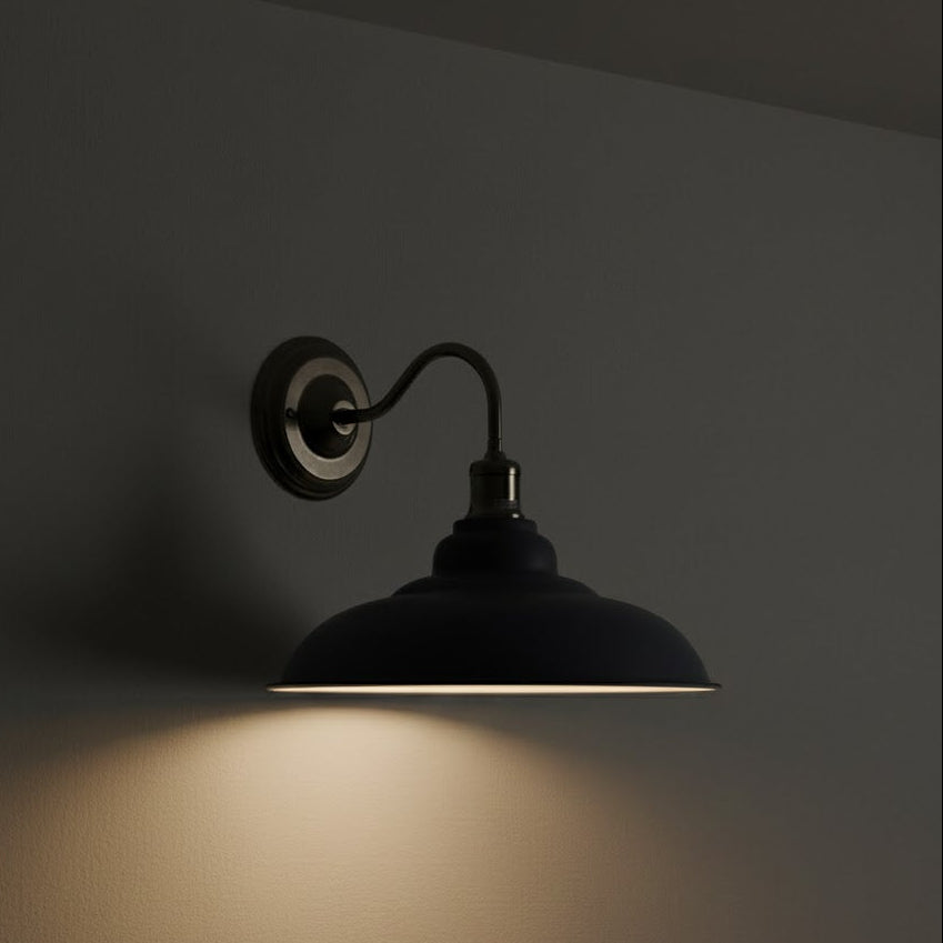 wall-mounted lamp casting a warm glow on a dark wall