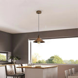 Modern kitchen with pendant light fixture, dining table, and chairs.