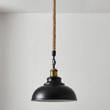 Black pendant light with a rope cord against a plain background
