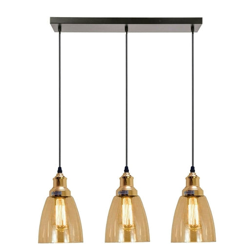 Three pendant lights with gold glass shades on a white background