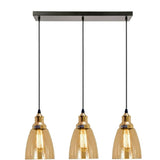 Three pendant lights with gold glass shades on a white background