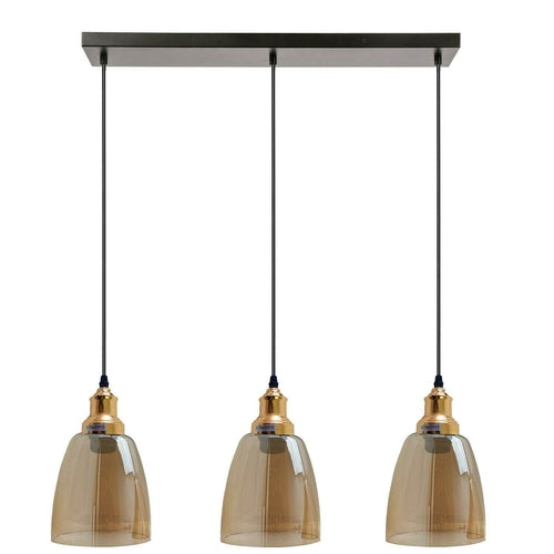 Three pendant lights with brown glass shades and gold accents on a white background