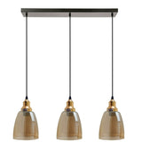 Three pendant lights with brown glass shades and gold accents on a white background