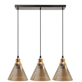 Three pendant lights with brown glass shades and gold accents on a white background