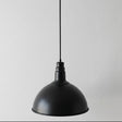 Black pendant light on a gray background