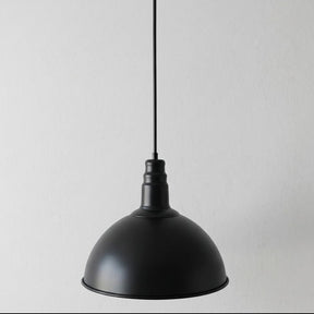 Black pendant light on a gray background